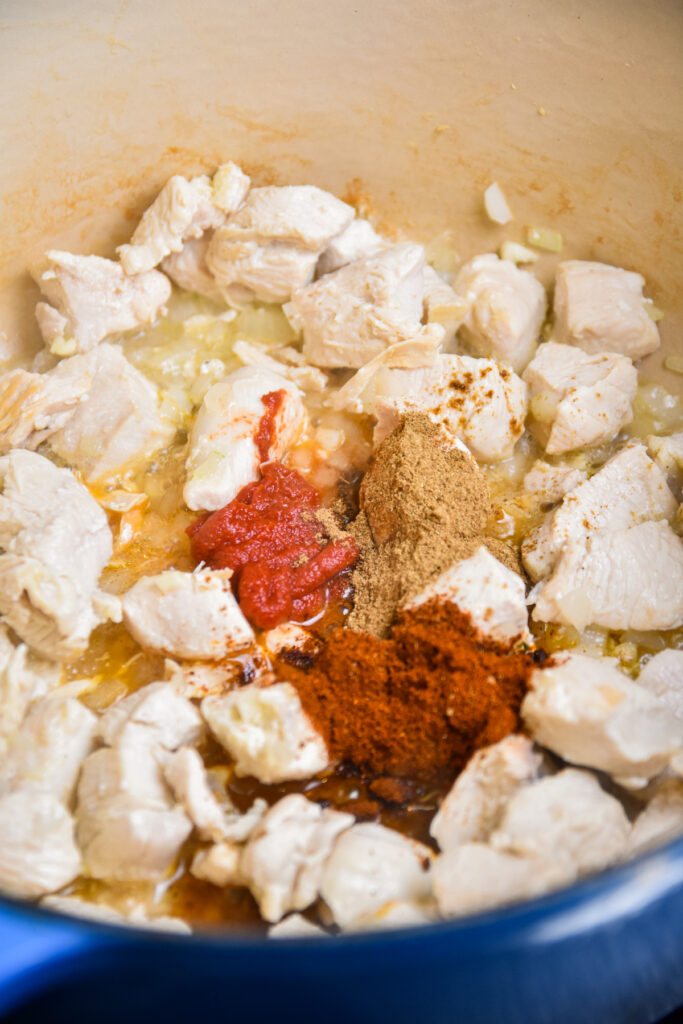 Cooked chicken breast with tomato paste and seasonings.