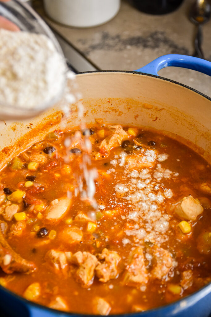Adding masa to thicken chicken enchilada soup.