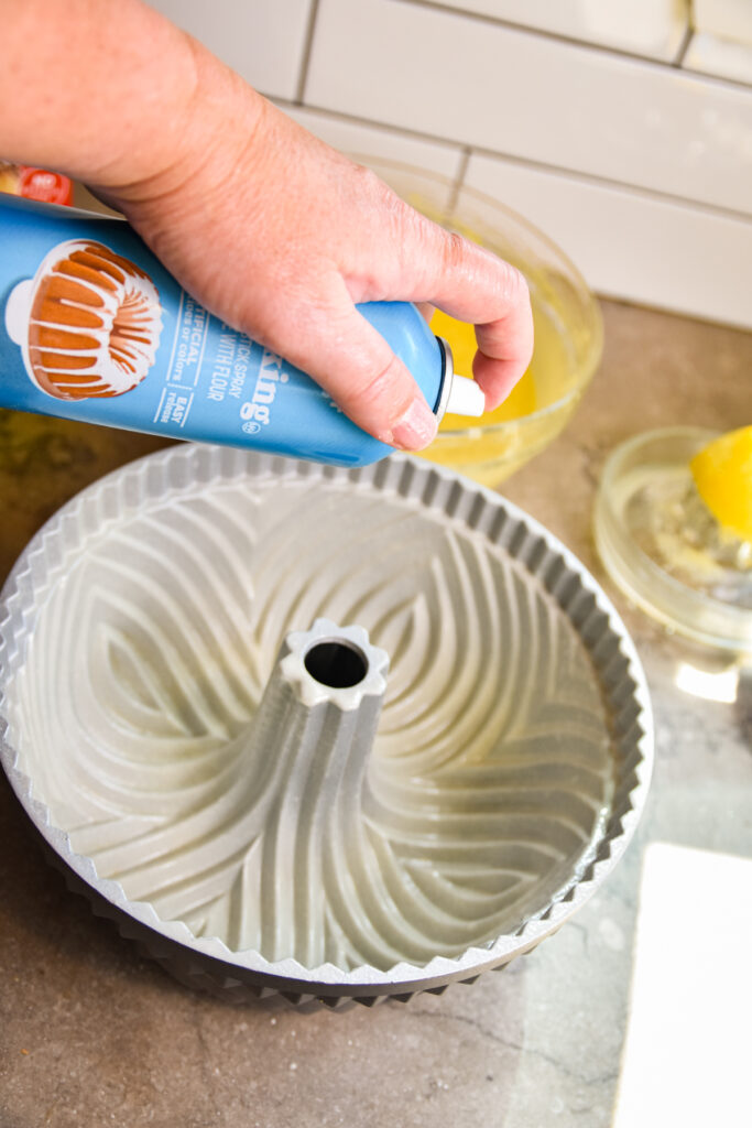 Spraying bundt cake pan with baking spray.