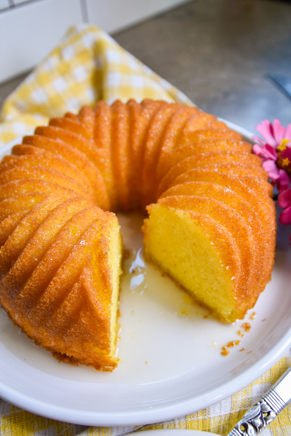 jello-cake-with-powdered-sugar Lemon jello cake with slice cut out.
