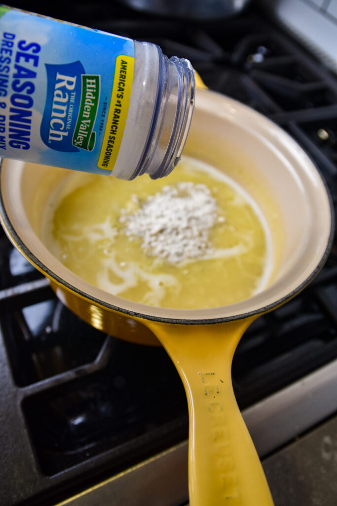 Adding ranch seasoning to rue for casserole.
