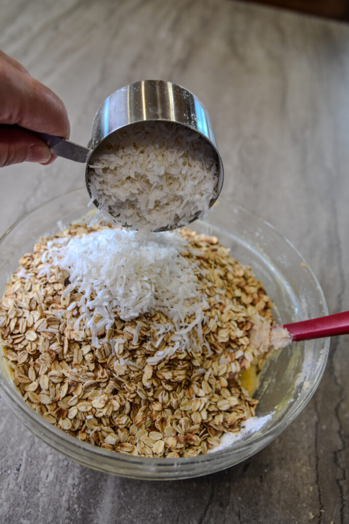 Adding coconut to bonnie doone cookie dough.