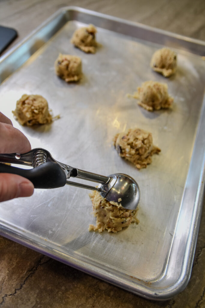 Scooping Bonnie Doone cookie dough onto cookie sheet.