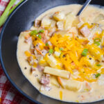 Bowl of cheesy ham and potato soup.