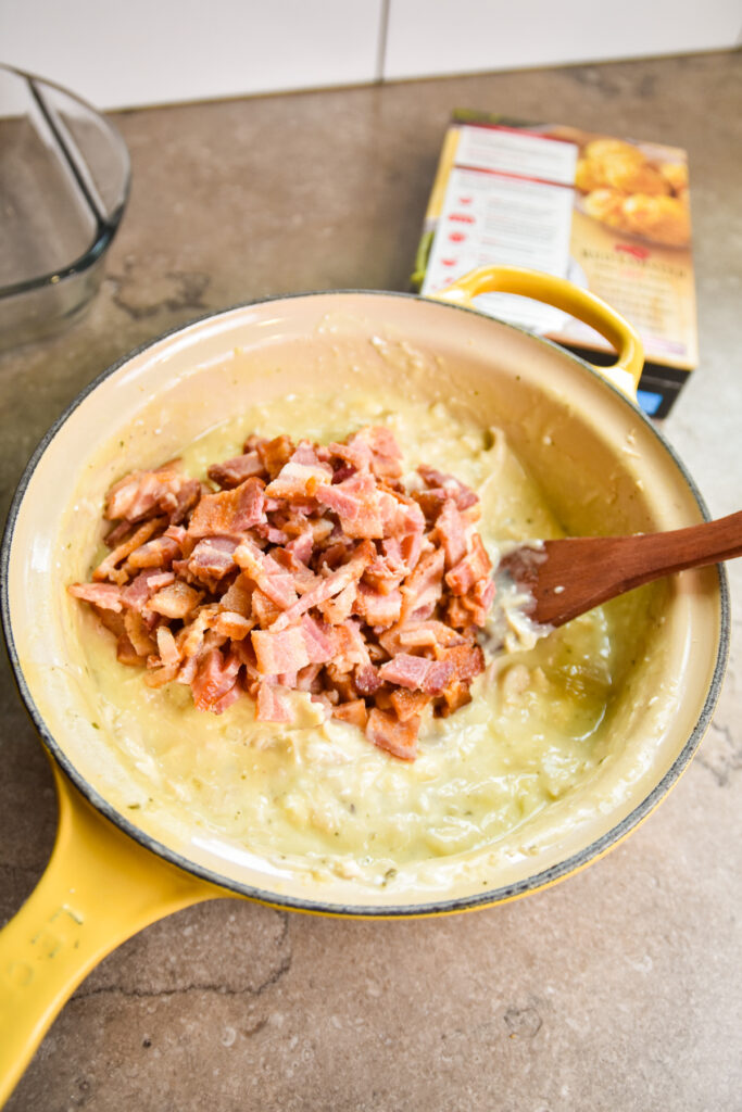 Adding bacon to chicken bacon ranch casserole filling.