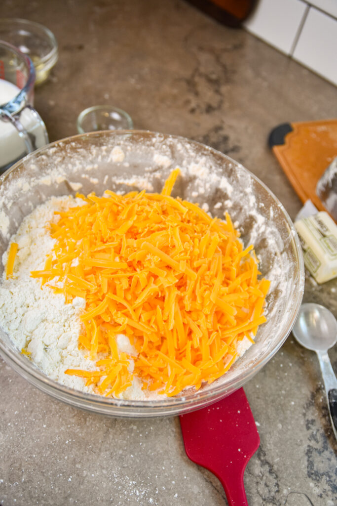 Adding shredded cheddar to cheddar bay biscuits