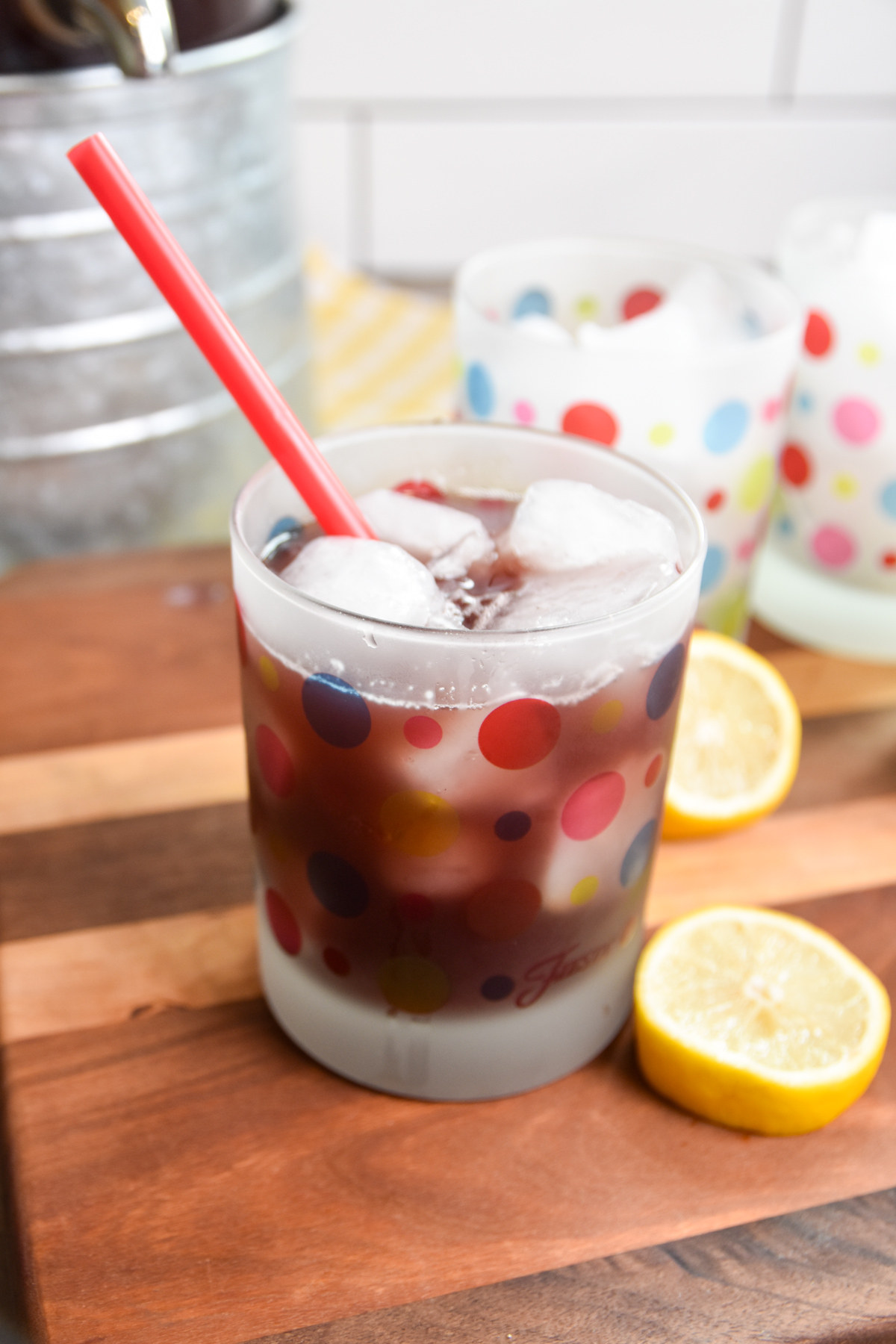 Glass of purple party punch with red straw