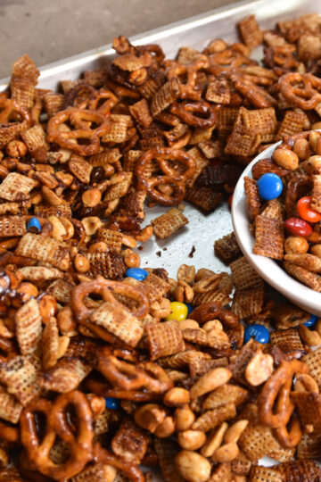 Sorghum cereal snack mix with Rice Chex, pretzels, nuts, and M&Ms in a serving bowl
