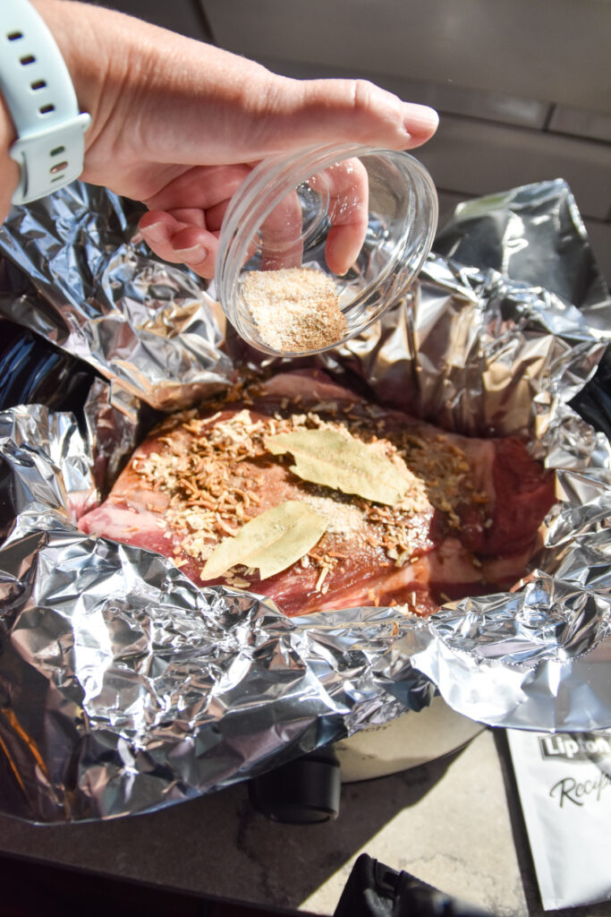 Adding seasonings to Easy Slow Cooker Beef Brisket